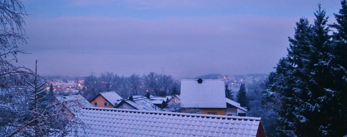 Snow-covered rooftops looking out over my village in Germany