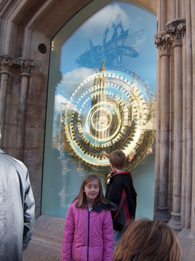 The fabulous Corpus Clock in Cambridge, England--revealing less of itself in the gleaming sun and more of a reflection of King's College.