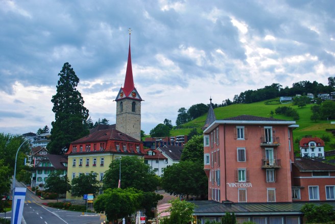 Bright buildings and green hills.